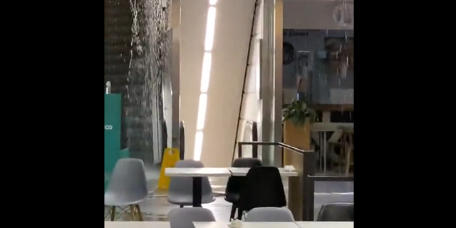 Water is seen coming out of the ceiling near an escalator inside the El Corte Ingles shopping mall in Lisbon, Portugal.