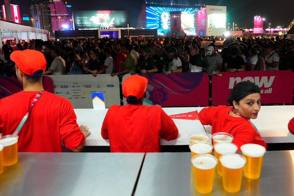 Fans wait in line for beer at a fan zone ahead of the FIFA World Cup, in Doha, Qatar Saturday, Nov. 19, 2022. 