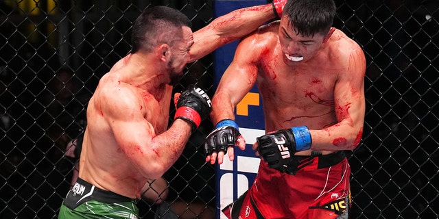 Rafa Garcia punches Maheshate of China in a lightweight fight during the UFC Fight Night event at UFC APEX on December 17, 2022 in Las Vegas, Nevada.