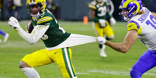 Los Angeles Rams wide receiver Ben Skowronek (18) tries to tackle Green Bay Packers cornerback Rasul Douglas (29) after an interception in the second half of an NFL football game in Green Bay, Wis. Monday, Dec. 19, 2022. 