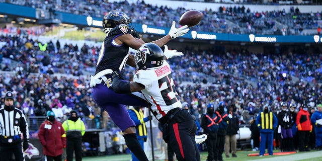 Baltimore Ravens wide receiver Demarcus Robinson (10) pulls in a touchdown reception over Atlanta Falcons cornerback Cornell Armstrong during the first half of an NFL football game, Saturday, Dec. 24, 2022, in Baltimore.