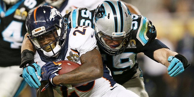 Ronnie Hillman #23 of the Denver Broncos is tackled by  Luke Kuechly #59 of the Carolina Panthers in the third quarter during Super Bowl 50 at Levi's Stadium on February 7, 2016 in Santa Clara, California.