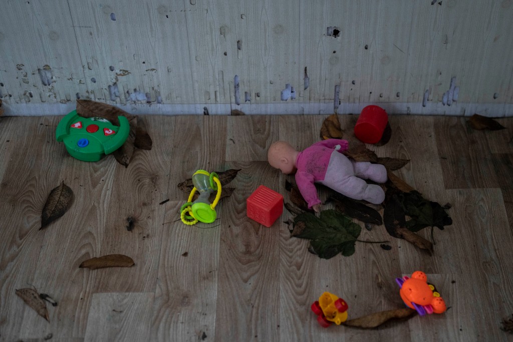 Toys and a doll lay on the floor of a playhouse in the courtyard of Kherson regional children's home in Kherson, Ukraine, on Nov. 25, 2022.  