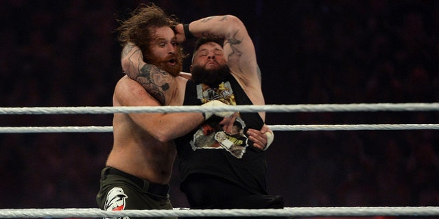 Sami Zayn, left, takes a Stunner from Kevin Owens during WrestleMania 37 at Raymond James Stadium April 11, 2021, in Tampa, Florida.