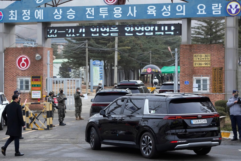 A convoy of vehicles, one of them carrying K-pop band BTS's member Jin, arrives at an army training center in Yeoncheon, South Korea, on Dec. 13, 2022.