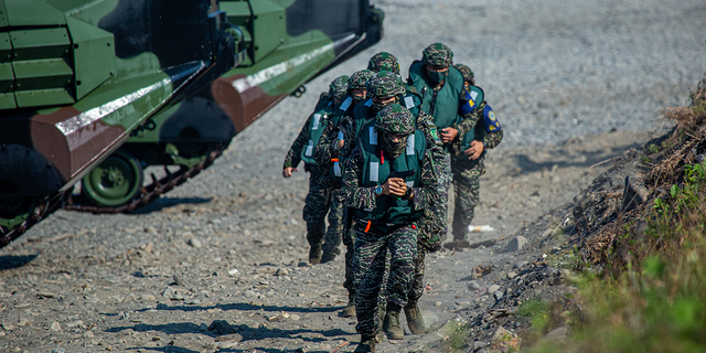 Soldiers disembark from AAV7 amphibious assault vehicles during the Han Kuang military exercise, which simulates China's People's Liberation Army invading the island, on July 28, 2022, in Pingtung, Taiwan.