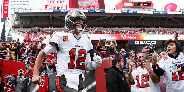 Tom Brady runs onto the field before the San Francisco 49ers game in Santa Clara, California, on Dec. 11, 2022.