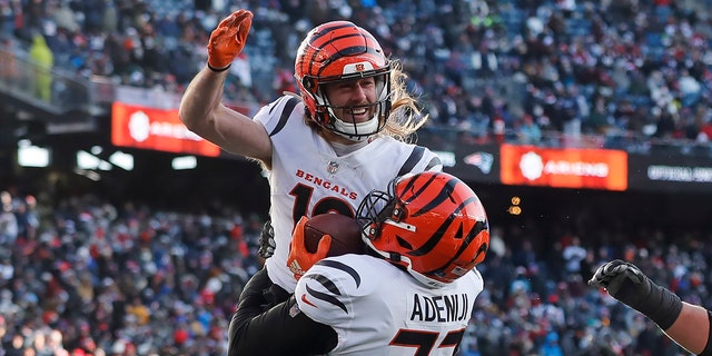 Cincinnati Bengals wide receiver Trenton Irwin, top, celebrates his touchdown with Cincinnati Bengals guard Hakeem Adeniji, #77, during the first half of an NFL football game against the New England Patriots, Saturday, Dec. 24, 2022, in Foxborough, Massachusetts.