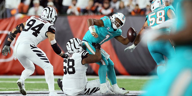 Quarterback Tua Tagovailoa, #1 of the Miami Dolphins, is sacked by defensive tackle Josh Tupou, #68 of the Cincinnati Bengals, during the 2nd quarter of the game against the Cincinnati Bengals at Paycor Stadium on Sept. 29, 2022 in Cincinnati.