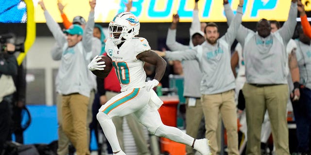 Miami Dolphins wide receiver Tyreek Hill runs for a touchdown after recovering a fumble during the first half against the Los Angeles Chargers, Sunday, Dec. 11, 2022, in Inglewood, California.