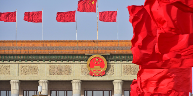 Red flags flutter in front of the Great Hall of the People before the annual two sessions March 4, 2022, in Beijing, China.