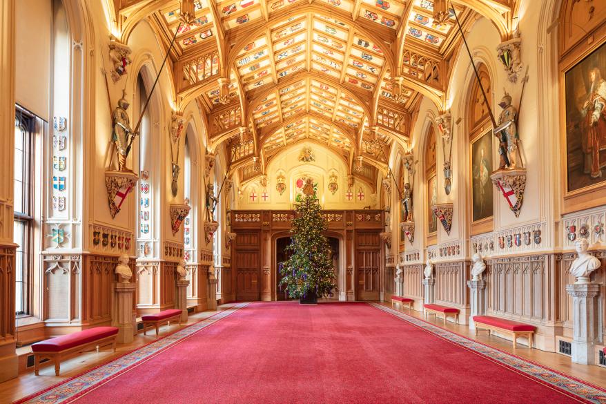 The 20-foot-high Nordmann Fir Christmas tree in St George’s Hall. The tree, which is sourced from Windsor Great Park, took two full days to decorate with 3,000 lights, hundreds of iridescent jewel-shaped ornaments, and purple velvet and satin ribbons.