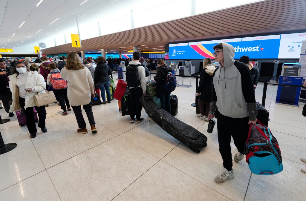 Travelers queue up to reach the check-in counters for Southwest Airlines in Denver International Airport 