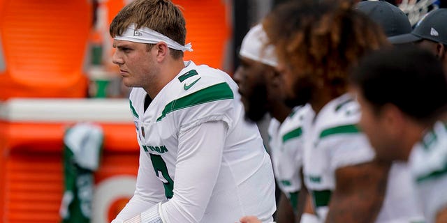 New York Jets quarterback Zach Wilson sits on the bench during the Tennessee Titans game, Sunday, Oct. 3, 2021, in East Rutherford, New Jersey.