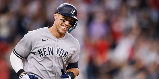 Aaron Judge of the New York Yankees rounds the bases after hitting his 62nd home run of the season against the Rangers at Globe Life Field on Oct. 4, 2022, in Arlington, Texas.