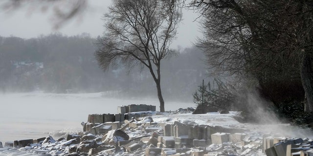 Steam rises off of Lake Michigan as morning temperatures remain below zero with heavy winds Friday, Dec. 23, 2022, in Fox Point, Wis.