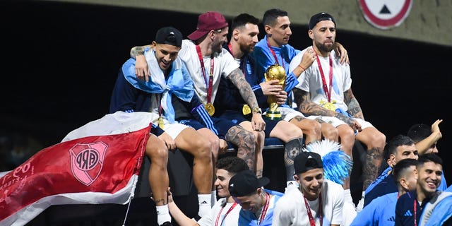 World Cup champions, from left, Leandro Paredes, Rodrigo De Paul, Lionel Messi, Angel Di Maria and Nicolas Otamendi celebrate on Dec. 20, 2022, in Buenos Aires, Argentina.