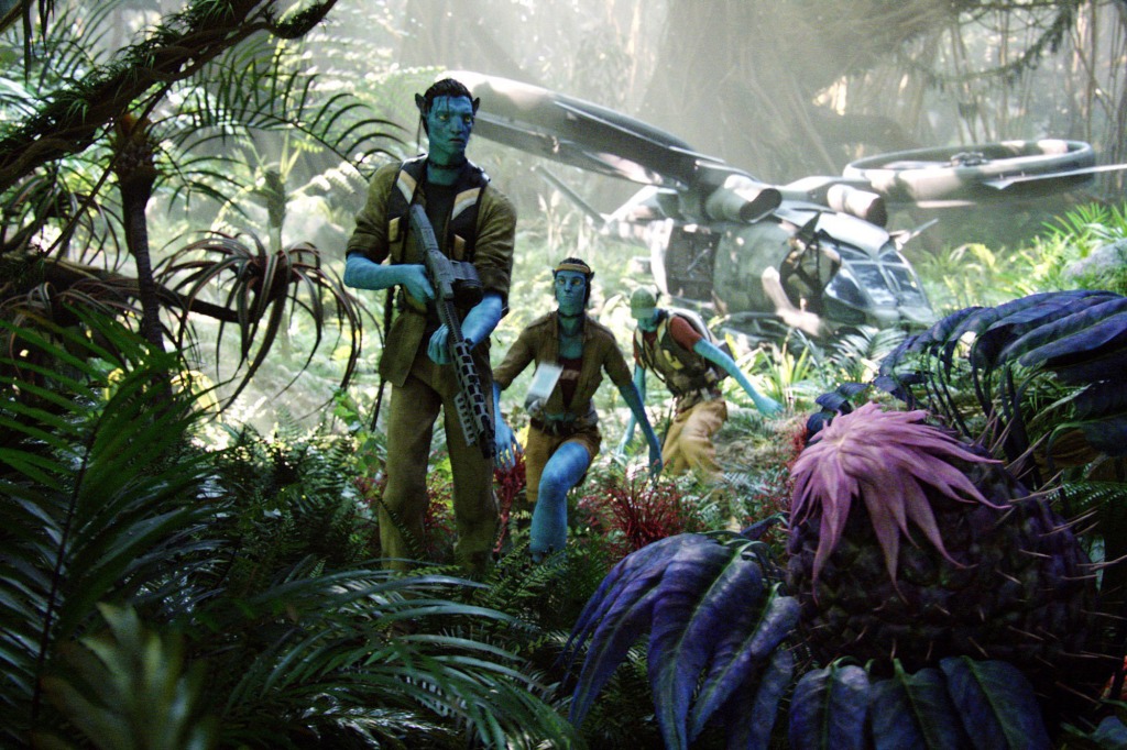 Sam Worthington with children in "Avatar" in a jungle. 