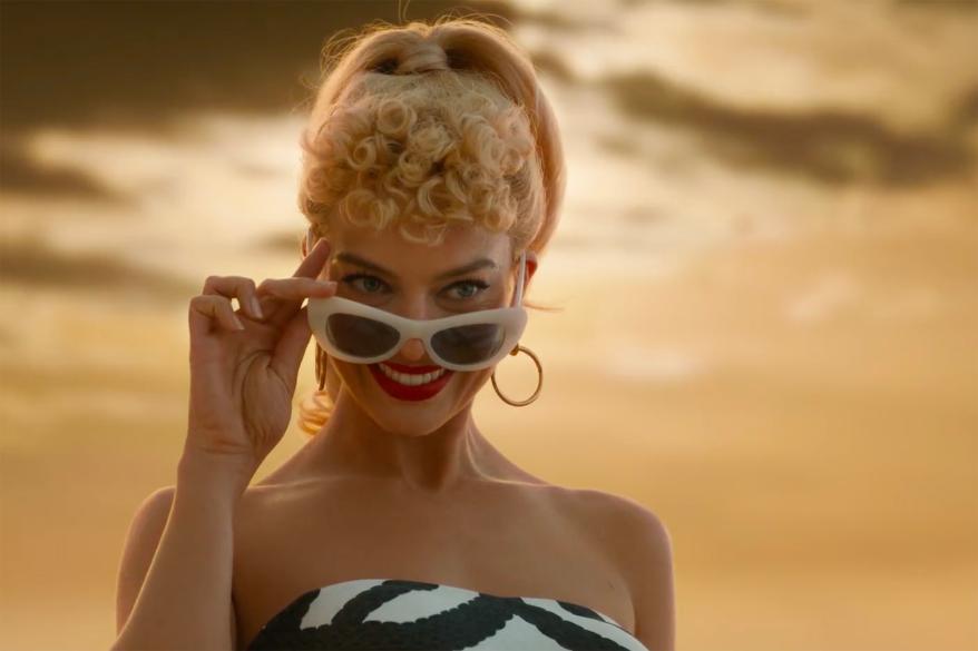 The trailer shows a larger-than-life Barbie, played by Margot Robbie.