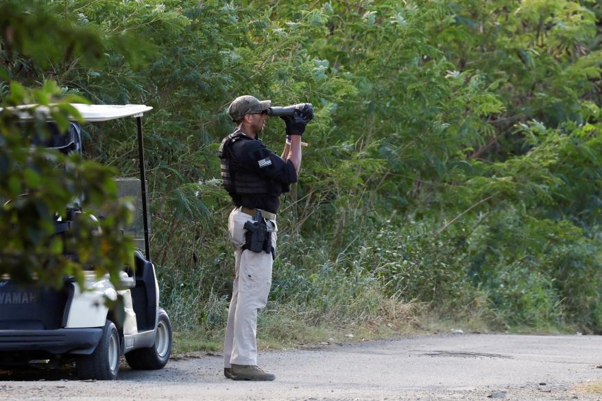 U.S. Secret Service counter-assault team agents protect President Joe Biden as he plays golf with his grandson.