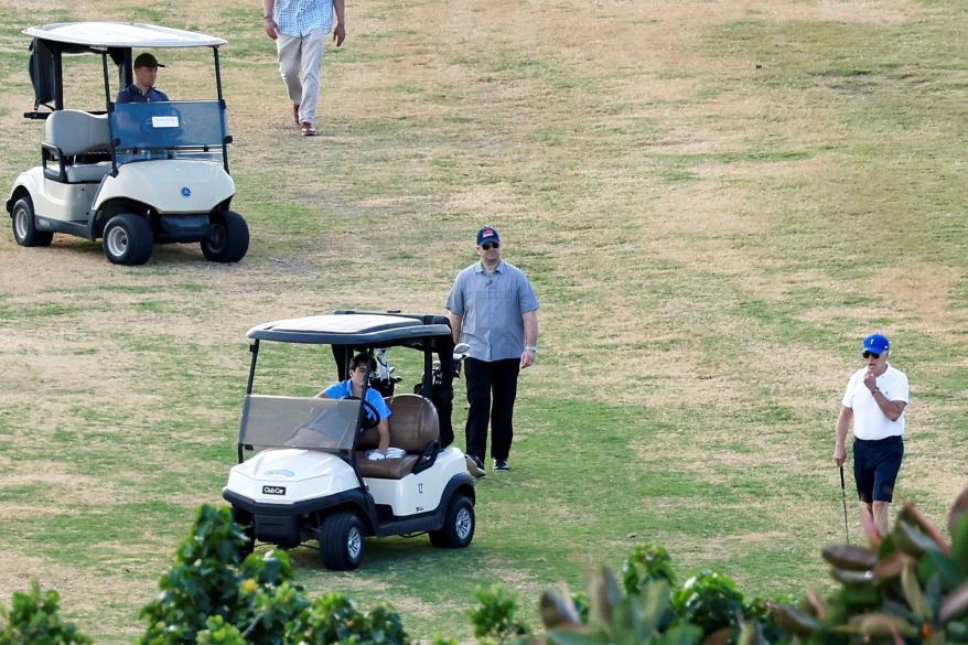 U.S. President Joe Biden plays golf with his grandson, Robert, who is known as "Hunter."