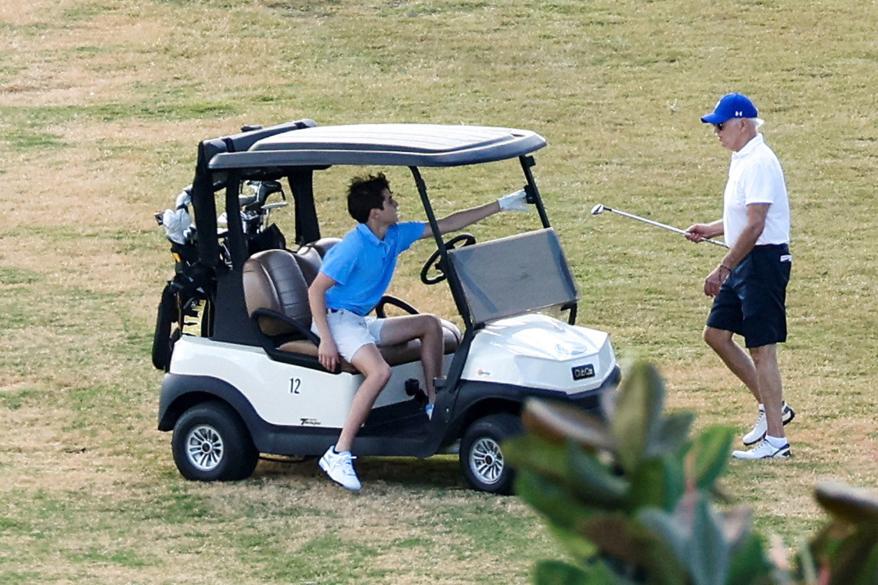 U.S. President Joe Biden plays golf with his grandson, Robert, who is known as "Hunter."
