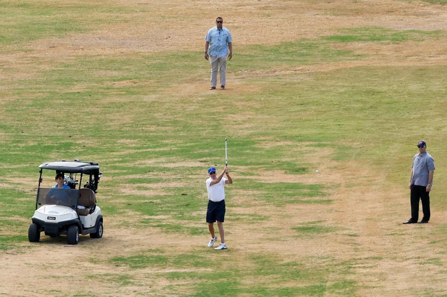 U.S. President Joe Biden plays golf with his grandson.