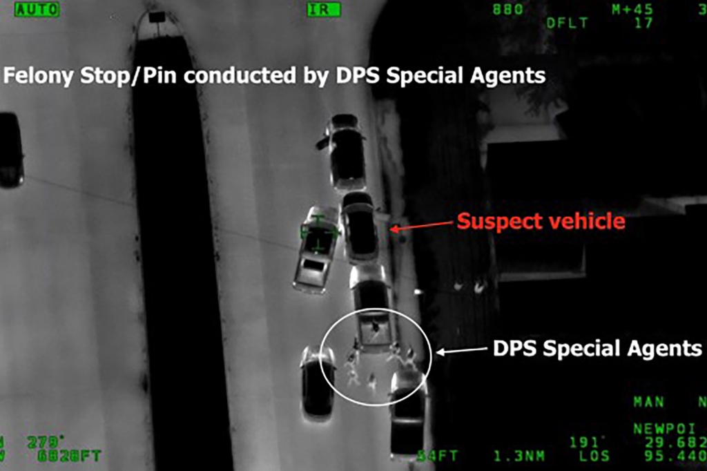 An infrared picture taken from a helicopter shows CID agents making a raid
