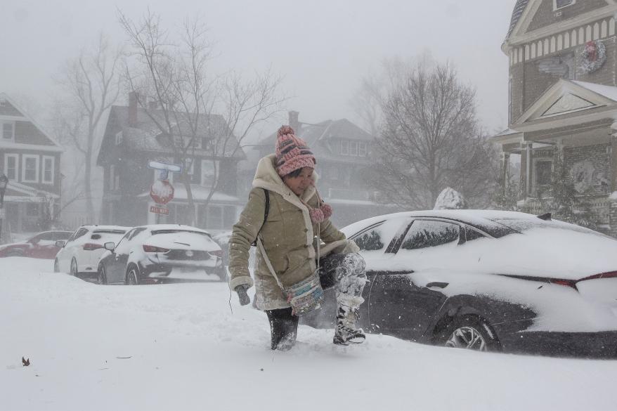 Jessica Chan of Buffalo, New York, navigates deep snow as a large winter storm, which is affecting large portions of the United States, continues to hit Buffalo
