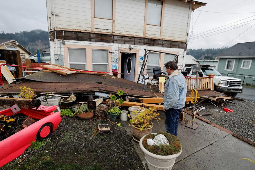 Homeowner Darren Gallagher looks at the collapsed second story porch of his house after a strong 6.4-magnitude earthquake struck off the coast of northern California, in Rio Dell, California, U.S. December 20, 2022.