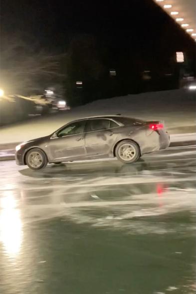 Car drives on frozen canal