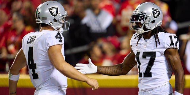 Davante Adams (17) of the Las Vegas Raiders celebrates after scoring a touchdown with teammate Derek Carr (4) against the Kansas City Chiefs during the second half at GEHA Field at Arrowhead Stadium Oct. 10, 2022, in Kansas City, Mo.