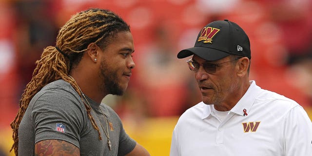 Chase Young of the Washington Commanders shakes hands with head coach Ron Rivera prior to a game against the Jacksonville Jaguars at FedEx Field Sept. 11, 2022, in Landover, Md.