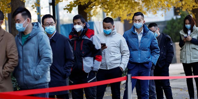 Chinese citizens line up for COVID tests in Beijing.