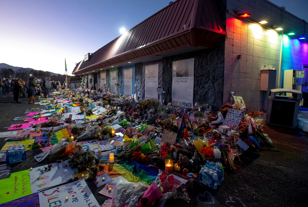 A memorial outside Club Q, where five were killed and 25 more injured in a shooting that is being probed as a hate crime.