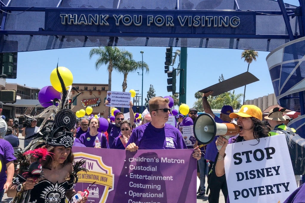 Disney workers and union employees march for higher wages at the Disneyland Resort in Anaheim, Ca., in June 2018.