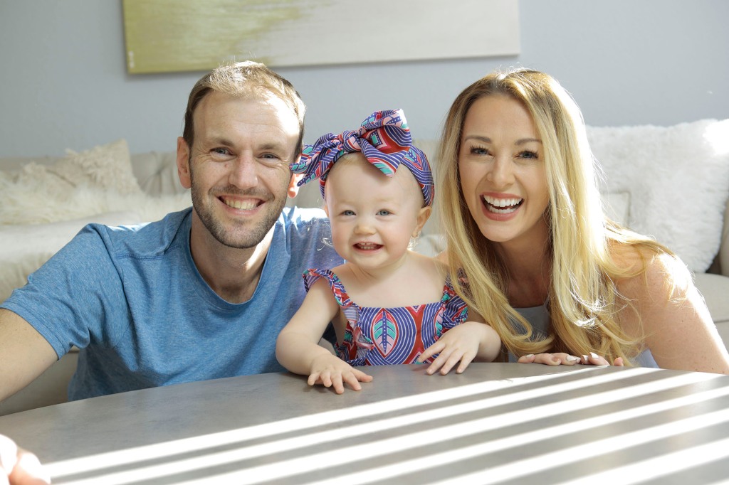 Jamie and Doug Hehner, from Season One of reality show Married At First Sight, photographed with their daughter.