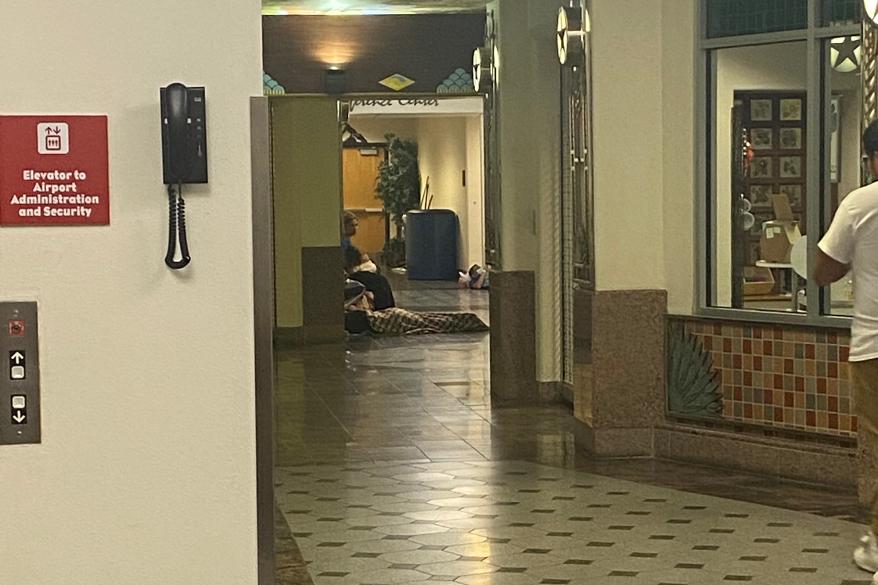 At El Paso International Airport, migrants sleep in a designated area with cots with they have a flight in the morning and less than a 12-hour wait.