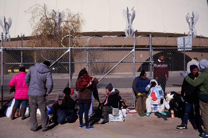 Migrants gather near a Grayhound bus station on Dec. 16, 2022 in El Paso, Texas.