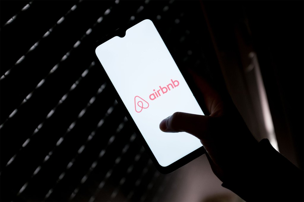 Airbnb logo on smart phone screen