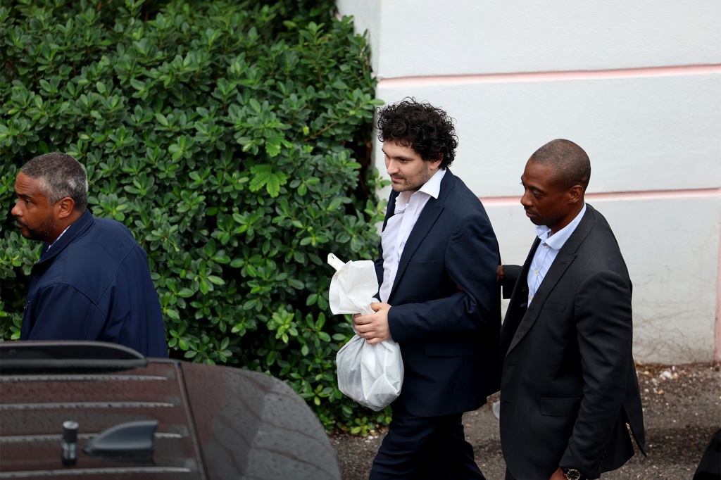 Sam Bankman-Fried in the Bahamas on Wednesday being moved to a car for his extradition back to the US.