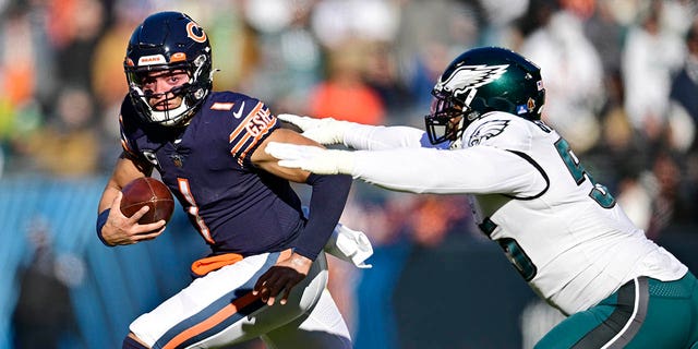 Justin Fields of the Bears avoids a tackle from Brandon Graham of the Philadelphia Eagles at Soldier Field on Dec. 18, 2022, in Chicago.