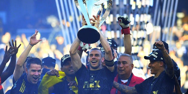 Gareth Bale of Los Angeles FC lifts the championship trophy as he celebrates with teammates following the 2022 MLS Cup Final at Banc of California Stadium in Los Angeles on Nov. 5, 2022.