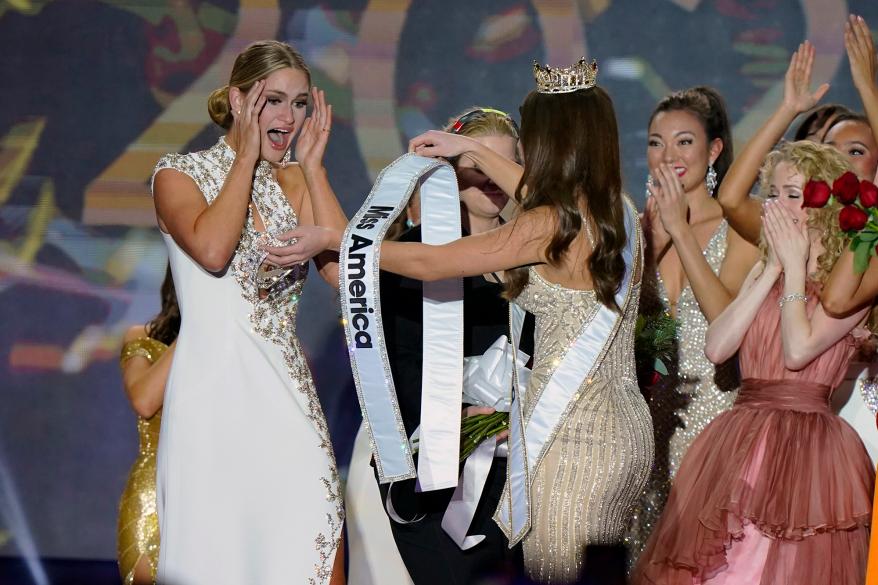Miss Wisconsin Grace Stanke, left, is presented with the Miss America 2023 sash by Miss America 2022 Emma Broyles