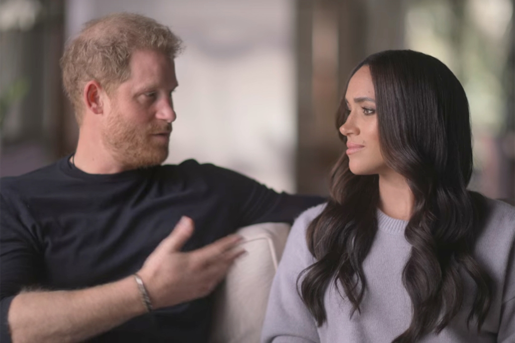 Prince Harry and Meghan Markle sitting on a couch together. 