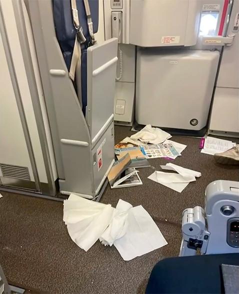 Supplies are seen scattered on the floor of the plane following violent turbulence Sunday.