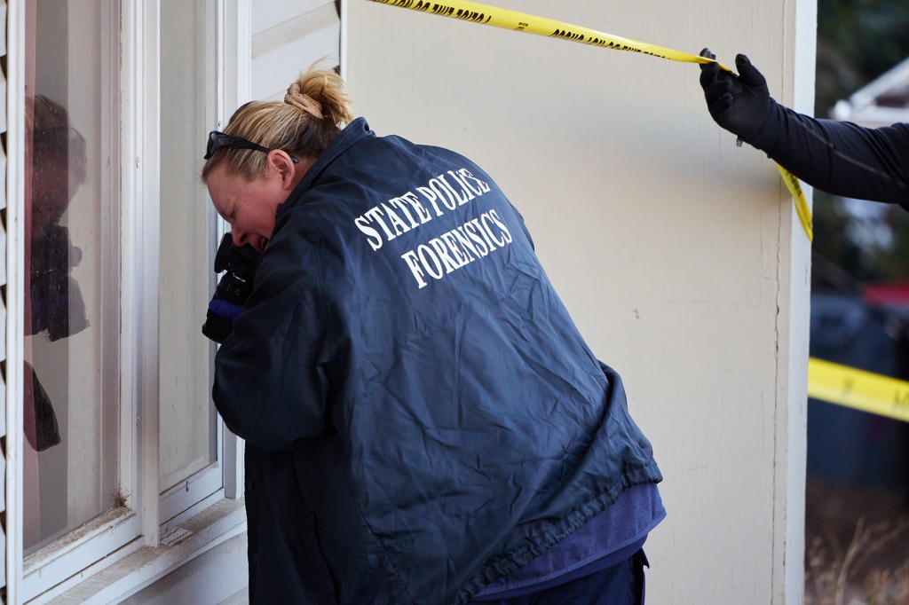 Investigators gather evidence in the front section of at an off-campus home where four University of Idaho students were stabbed to death.