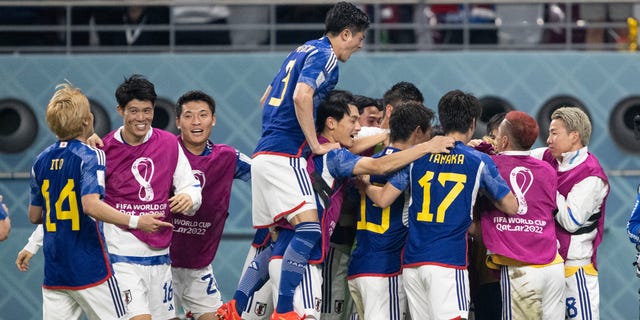 Japan players celebrate the game-tying goal during the World Cup Group E match against Spain at Khalifa International Stadium on Dec. 1, 2022, in Doha, Qatar.