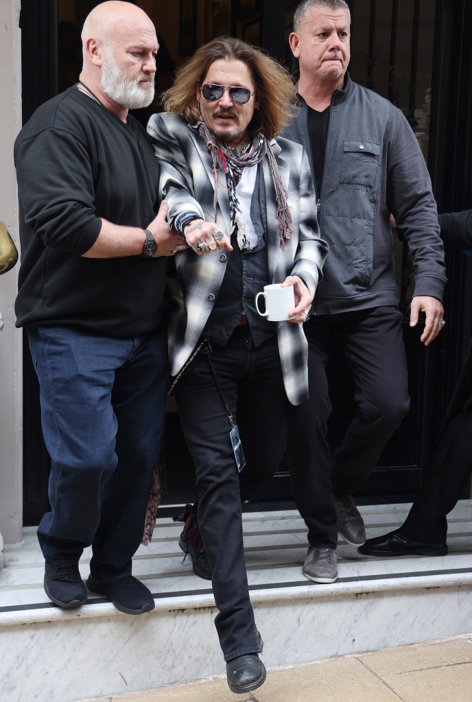 Johnny Depp seen needing help while leaving The Grand Hotel in Birmingham.