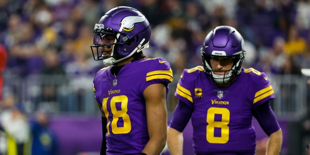 Justin Jefferson (18) and Kirk Cousins (8) of the Minnesota Vikings against the New England Patriots in the second quarter of a game at U.S. Bank Stadium in Minneapolis. The Vikings defeated the Patriots 33-26.